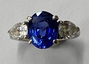 A Stunning Platinum oval Sapphire and pear shaped Diamond three stone ring for June 18th