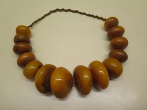 Largest Amber necklace to come to the auction A string of large pebble shaped butterscotch amber beads, largest 6cm x 6cm x 3cm, smallest 3.5cm x 2.5cm, total weight approx 675 grams